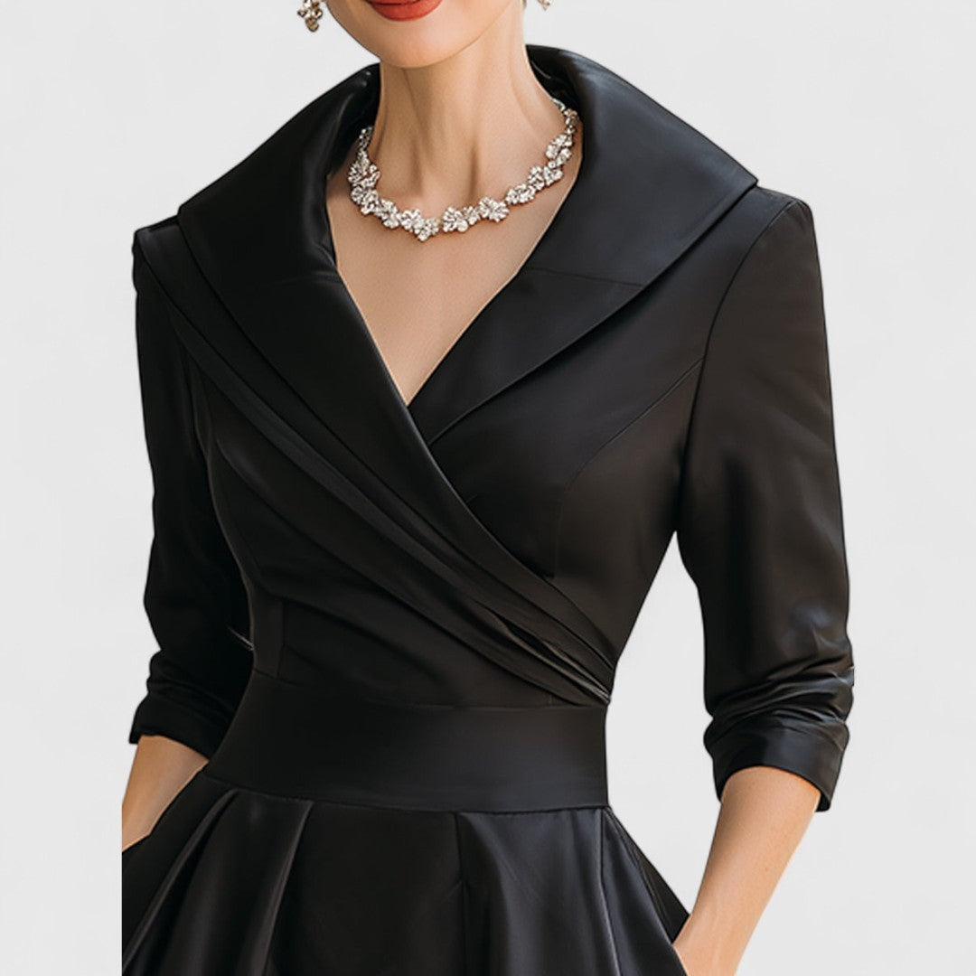 Close-up of black satin dress collar and wrap neckline detail