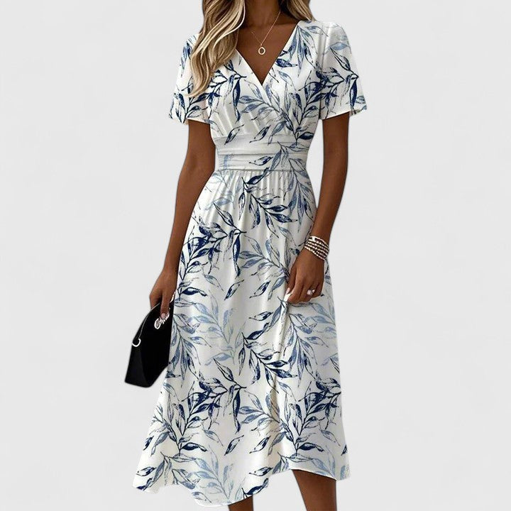V-neck floral midi dress featuring navy leaf pattern and cinched waist