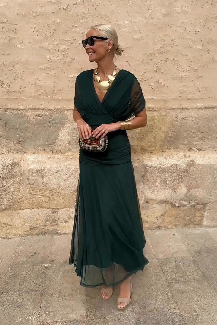 emerald green maxi dress with draped V-neck and flowing mesh skirt