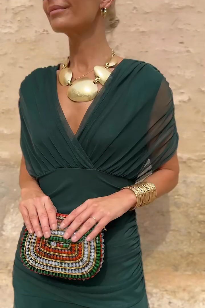 close-up of ruched waist on dark green V-neck maxi dress