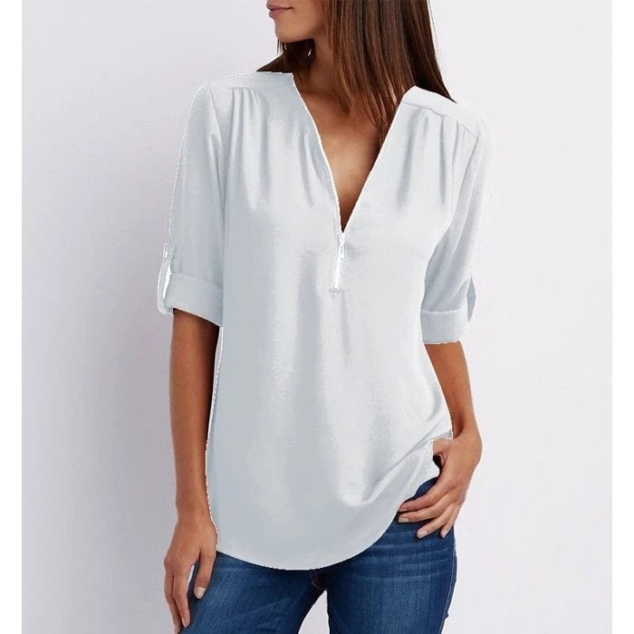 Light blue zip-front V-neck top featuring cuffed half sleeves