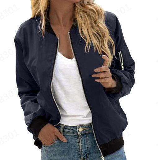 Navy bomber jacket showing sculpted fit with black ribbed collar and cuffs